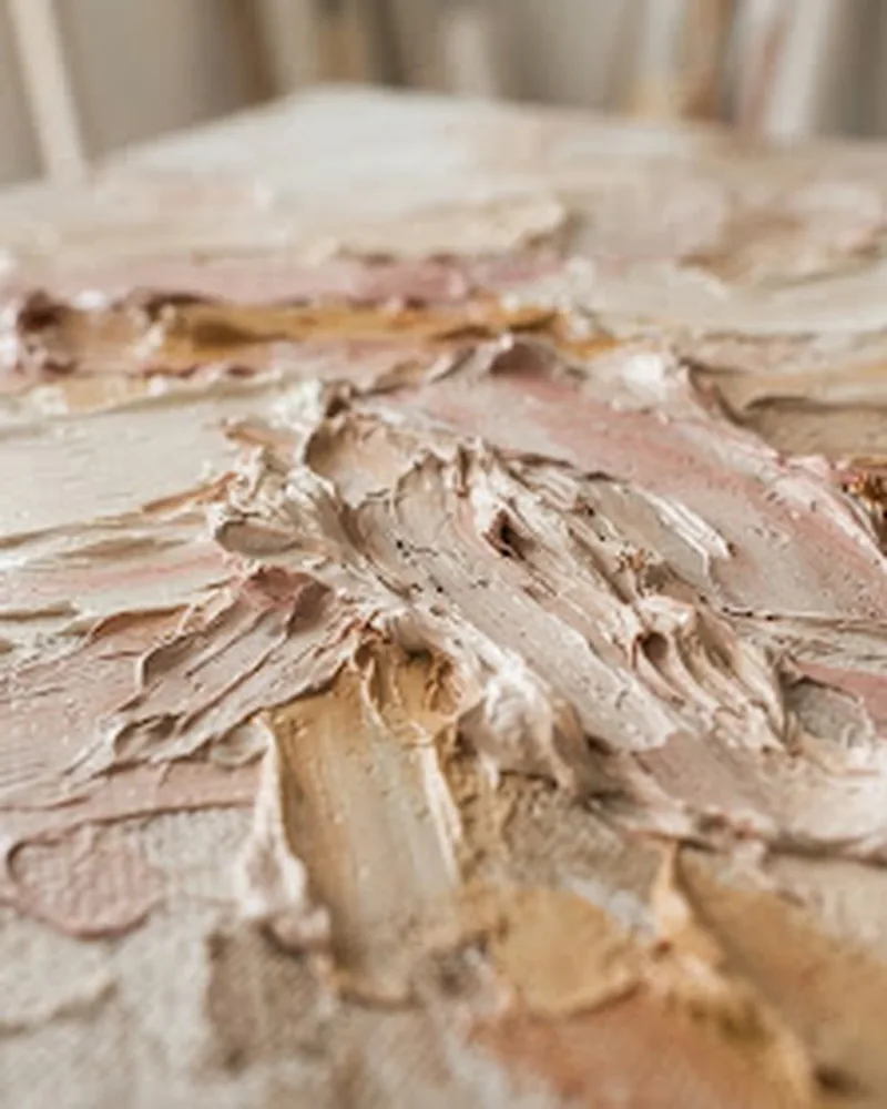 Palette-knife oil paint in creamy whites, dusty pinks and warm beige, lit to show the impasto ridges
