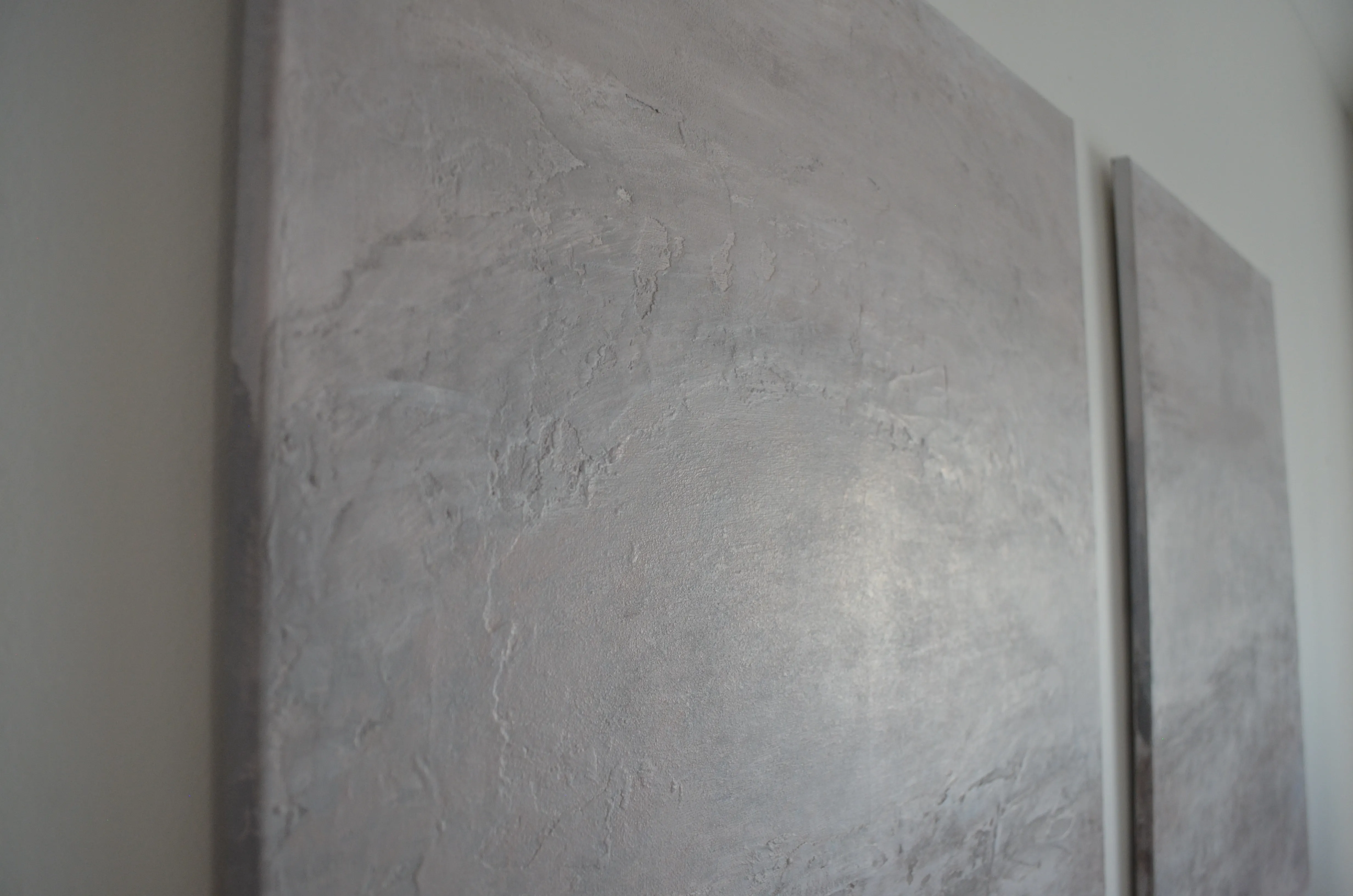 Close-up of thick, textured oil paint applied with a palette knife in creamy whites, dusty pinks and warm beige