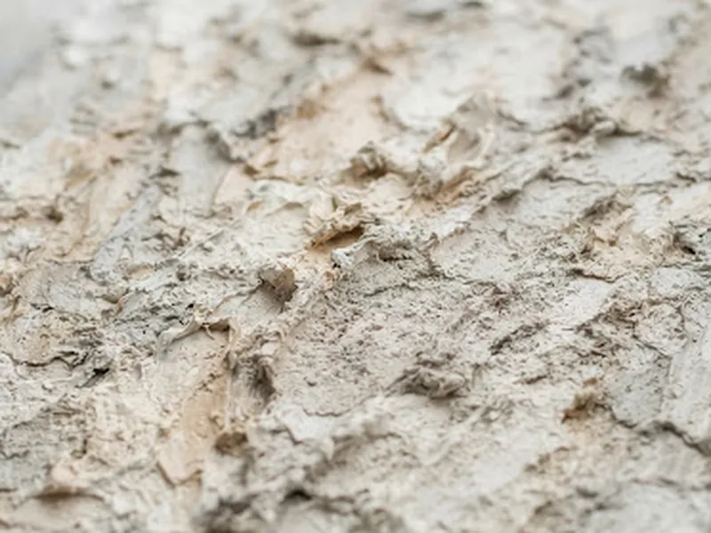 Close-up of thick impasto oil paint blending soft whites, subtle greys and warm beige