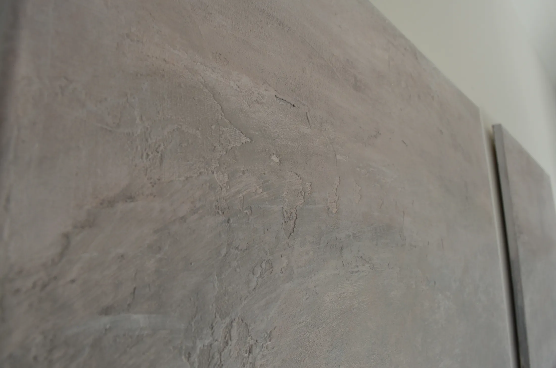 Extreme close-up of the hand-worked plaster texture in Misty Horizon, revealing fine tonal variation across the canvas