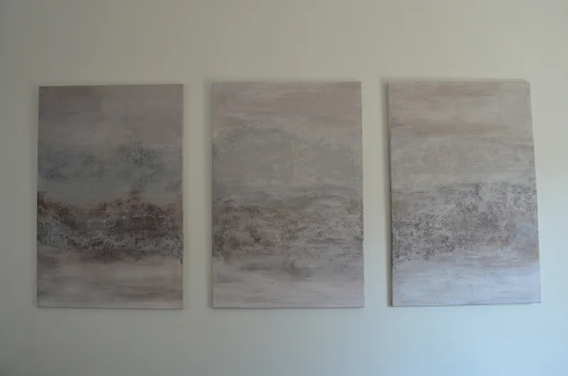 Misty Horizon — a three-panel textured triptych in soft dove-grey, dusty blush and warm taupe, displayed together on a gallery wall