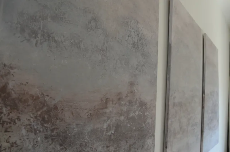 Detail of the layered, weathered texture in Misty Horizon, catching natural light across the muted grey and rose surface
